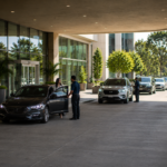 Parking Management Valet attendants assisting guests and managing vehicle flow at a modern hotel parking drop-off entrance.