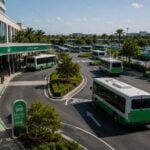Shuttle transportation hub with coordinated vehicle loading areas, designated pickup zones, and organized traffic flow supporting off-site parking operations.